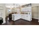 Bright kitchen boasts white cabinetry, pendant lighting, and hardwood floors with an adjacent dining area at 1938 E 11Th St, Indianapolis, IN 46201
