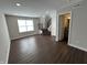 Spacious living area showcasing wood-look floors and a staircase at 3534 Brampton Ln, Westfield, IN 46074