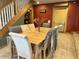 Elegant dining space highlighted by natural wood stairs, a decorative hutch, and seating for six at 7934 S 600 W, Edinburgh, IN 46124