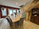 Inviting dining area with a spacious table, staircase, and traditional decor creating a warm ambiance at 7934 S 600 W, Edinburgh, IN 46124