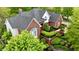 Lovely aerial view of a brick home surrounded by beautiful landscaping and mature trees at 2838 Silverwood Ln, Greenwood, IN 46143