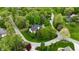 Aerial view of a home surrounded by lush greenery and a well-manicured lawn at 2838 Silverwood Ln, Greenwood, IN 46143
