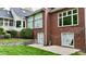 Red brick exterior and backyard with walkout basement, patio, and stone retaining wall at 2838 Silverwood Ln, Greenwood, IN 46143