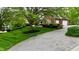 Traditional home with an expansive front lawn, mature trees, and a private driveway at 2838 Silverwood Ln, Greenwood, IN 46143