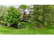 Well-maintained front exterior with mature trees, manicured lawn, and brick accents at 2838 Silverwood Ln, Greenwood, IN 46143