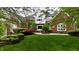 Charming two-story brick home with a lush green lawn and beautifully landscaped garden at 2838 Silverwood Ln, Greenwood, IN 46143