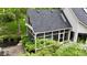 Sunroom with a dark roof surrounded by trees and brick patio at 2838 Silverwood Ln, Greenwood, IN 46143