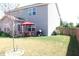 Backyard with grassy area, a red umbrella, and a fenced perimeter at 882 Brookshire Dr, Franklin, IN 46131