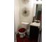 Cozy half bathroom featuring striking decor, a granite-look vanity, and dark vinyl flooring at 882 Brookshire Dr, Franklin, IN 46131