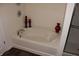 Clean and inviting bathtub with decorative accents, perfect for relaxation and unwinding at 882 Brookshire Dr, Franklin, IN 46131