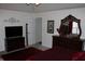 Comfortable bedroom featuring a modern TV, dresser with ornate mirror, and elegant red accents at 882 Brookshire Dr, Franklin, IN 46131