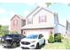 Two-story home with a two-car garage, and front yard parked cars at 882 Brookshire Dr, Franklin, IN 46131