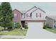 Charming two-story home with a well-manicured lawn and a two car garage at 882 Brookshire Dr, Franklin, IN 46131