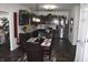 Open-concept kitchen features dark cabinets, stainless appliances, and granite countertops at 882 Brookshire Dr, Franklin, IN 46131