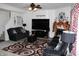 Comfortable living room with a TV, fireplace, and dark sofas at 882 Brookshire Dr, Franklin, IN 46131