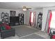 Spacious living room with a ceiling fan, modern shelving, plush carpet, and black and white decor at 882 Brookshire Dr, Franklin, IN 46131