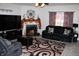 Cozy living room with fireplace, dark furniture, and a patterned area rug at 882 Brookshire Dr, Franklin, IN 46131