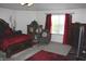 Well-lit main bedroom with elegant red accents, carpet floors, and large window at 882 Brookshire Dr, Franklin, IN 46131