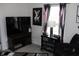 Functional home office setup with a sleek TV, modern lamp, and stylish decorative items at 882 Brookshire Dr, Franklin, IN 46131