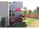 Backyard patio with red-cushioned furniture and a BBQ grill near a wood fence at 882 Brookshire Dr, Franklin, IN 46131