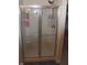 Modern shower featuring sliding glass doors, built-in shelves, and sleek fixtures at 882 Brookshire Dr, Franklin, IN 46131