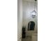 Carpeted staircase illuminated by a modern chandelier and a decorative arched mirror at 882 Brookshire Dr, Franklin, IN 46131
