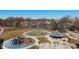 An aerial shot showing the community playground and splash pad, nestled amongst mature trees and neighborhood homes at 1817 Bellefontaine St, Indianapolis, IN 46202