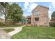 Exterior view featuring a brick facade, a lawn, and professional landscaping at 1817 Bellefontaine St, Indianapolis, IN 46202