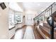 Inviting foyer with hardwood floors, staircase, and cozy window seat, offering a welcoming view of the neighborhood at 1817 Bellefontaine St, Indianapolis, IN 46202