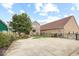 Charming two-story brick home featuring a concrete drive, lush landscaping, and welcoming entryway at 1817 Bellefontaine St, Indianapolis, IN 46202