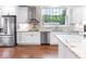 Bright kitchen showcasing stainless steel appliances, granite countertops, tile backsplash, and hardwood floors at 1817 Bellefontaine St, Indianapolis, IN 46202