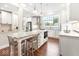 Bright, open kitchen featuring a large island with granite countertops, seating, and stainless steel appliances at 1817 Bellefontaine St, Indianapolis, IN 46202