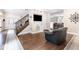 Open living room with hardwood floors, staircase, and view to the dining area at 1817 Bellefontaine St, Indianapolis, IN 46202