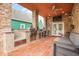 Covered outdoor kitchen with stainless steel appliances, a built-in grill, and seating at 1817 Bellefontaine St, Indianapolis, IN 46202