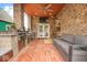 Covered outdoor kitchen with stainless steel appliances, a built-in grill, and seating at 1817 Bellefontaine St, Indianapolis, IN 46202