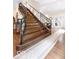 Elegant staircase with dark wood steps and iron railings, complemented by hardwood floors and neutral decor at 1817 Bellefontaine St, Indianapolis, IN 46202
