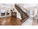 Elegant staircase with dark wood steps and iron railings, leading to a bright living space with stylish decor at 1817 Bellefontaine St, Indianapolis, IN 46202