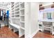Walk-in closet featuring built-in shelving, bench seating, and a vanity area with illuminated mirror at 1817 Bellefontaine St, Indianapolis, IN 46202