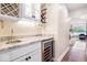 Wet bar featuring granite countertops, wine storage, glass racks, a small sink, and a wine fridge at 1817 Bellefontaine St, Indianapolis, IN 46202