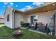 Backyard patio with outdoor seating, string lights, fire pit, and grassy lawn at 828 Ashton Park Dr, Greenwood, IN 46143