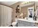 Well-lit bathroom featuring a vanity, decorative shelves, and a patterned shower curtain at 828 Ashton Park Dr, Greenwood, IN 46143