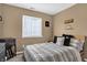 Cozy bedroom with natural light, a patterned bedspread, and a minimalist aesthetic for a peaceful retreat at 828 Ashton Park Dr, Greenwood, IN 46143