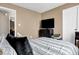 Bright bedroom with a comfortable bed, entertainment center, and neutral decor for a relaxing space at 828 Ashton Park Dr, Greenwood, IN 46143