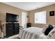 Comfortable bedroom with a large television, neutral walls, and stylish black furnishings for relaxation at 828 Ashton Park Dr, Greenwood, IN 46143