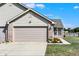 Home exterior with a large garage, driveway, and well-maintained landscaping at 828 Ashton Park Dr, Greenwood, IN 46143