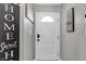 Welcoming foyer features a white door, stylish decor, and warm gray walls, creating an inviting entrance to the home at 828 Ashton Park Dr, Greenwood, IN 46143