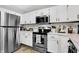 Modern kitchen with white cabinets and stainless steel appliances at 828 Ashton Park Dr, Greenwood, IN 46143