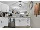 Bright kitchen with stainless dishwasher, sink, and white cabinets at 828 Ashton Park Dr, Greenwood, IN 46143