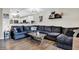 Inviting living room with a spacious sectional sofa, modern lighting, and views into the kitchen, perfect for comfortable living at 828 Ashton Park Dr, Greenwood, IN 46143