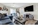 Cozy living area with a fireplace, dining table, and entertainment center, perfect for relaxing and entertaining guests at 828 Ashton Park Dr, Greenwood, IN 46143